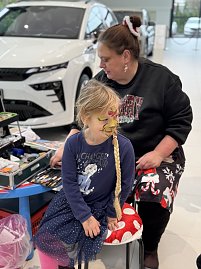 Ein Mädchen wird weihnachtlich geschminkt